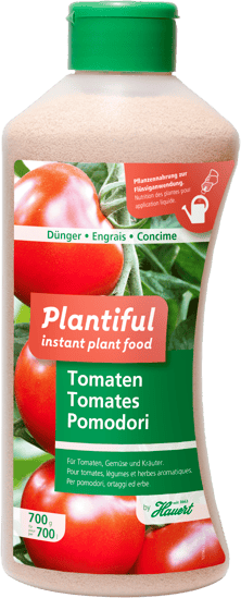 Eine Flasche mit Dünger für Tomatenpflanzen in Töpfen und im Garten